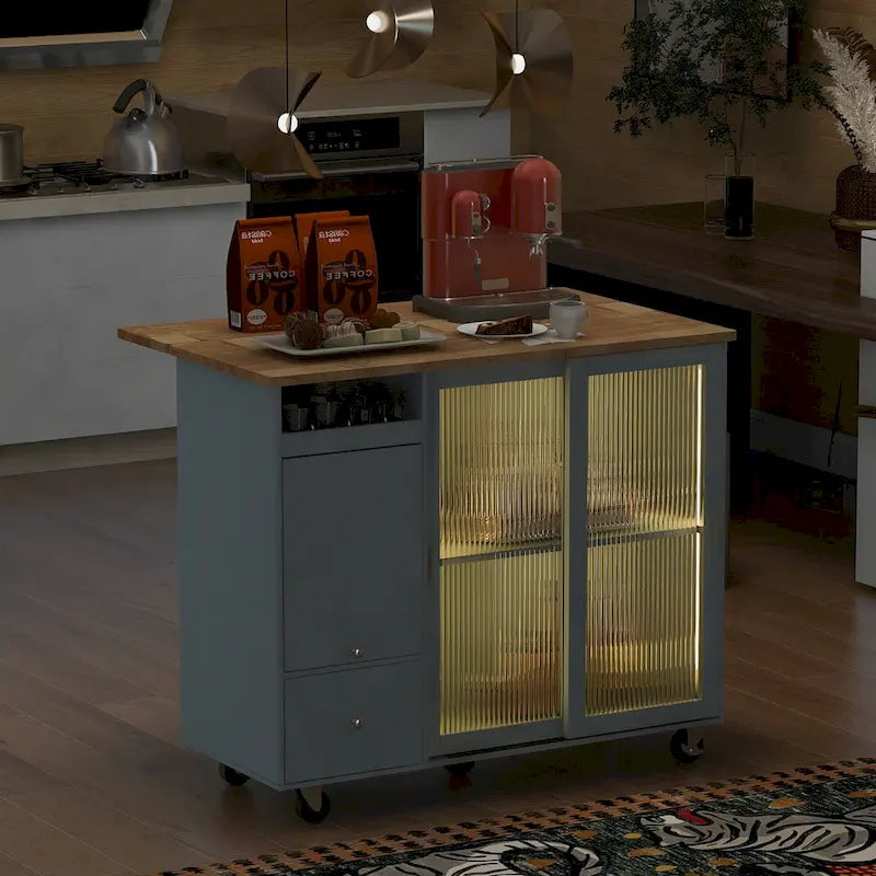 Wyspa kuchenna z opuszczanym blatem, oświetleniem LED, drzwiczkami z ryflowanego szkła, regulowaną półką, dwoma szufladami i kółkami