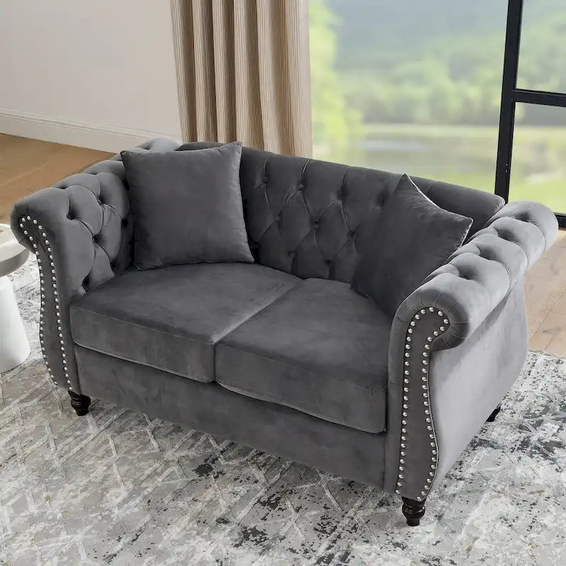 Causeuse chesterfield en velours, accoudoirs arrondis, garniture cloutée