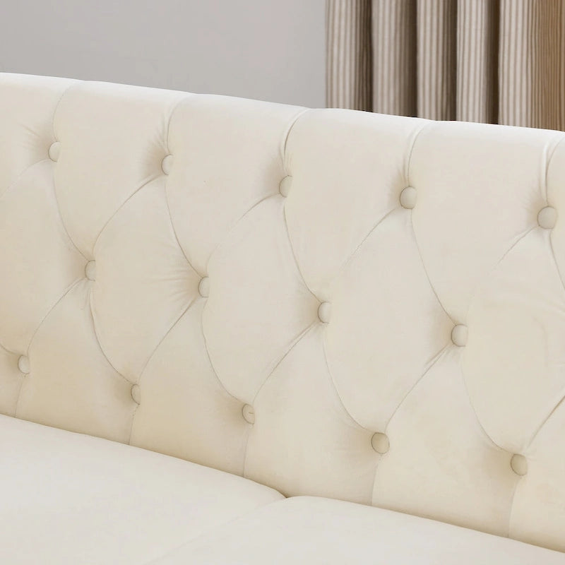Causeuse chesterfield en velours, accoudoirs arrondis, garniture cloutée